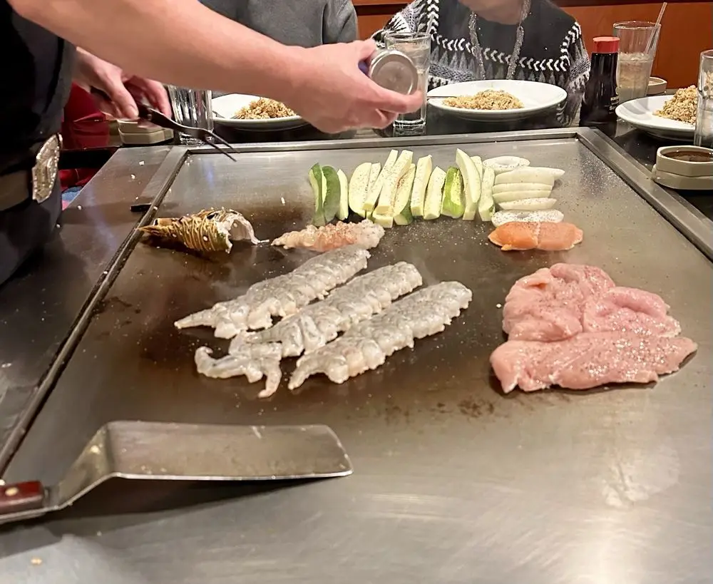 Hibachi chef entertaining guests during team building event