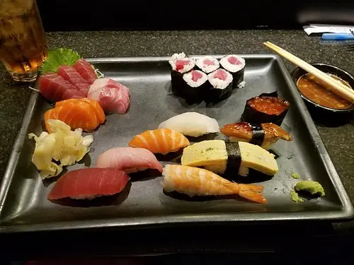 Fresh Jinbeh sushi platter featuring an assortment of nigiri and specialty rolls