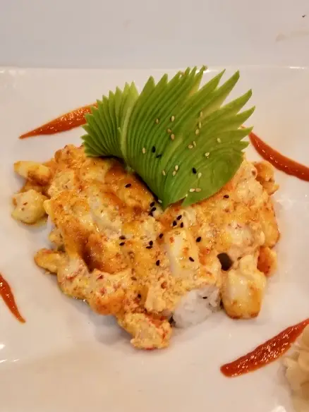 Volcano Roll, spicy crab and avocado with baked seafood topping