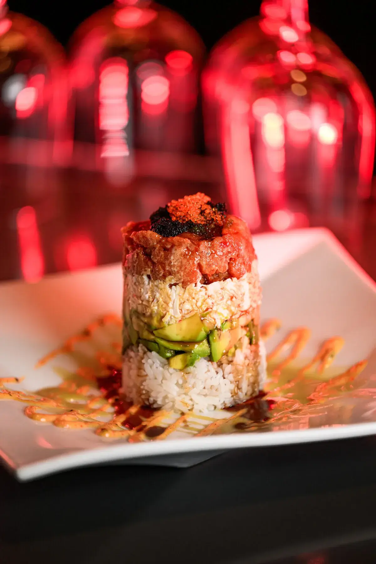 Jinbeh catering sushi tower with fresh rolls and sashimi