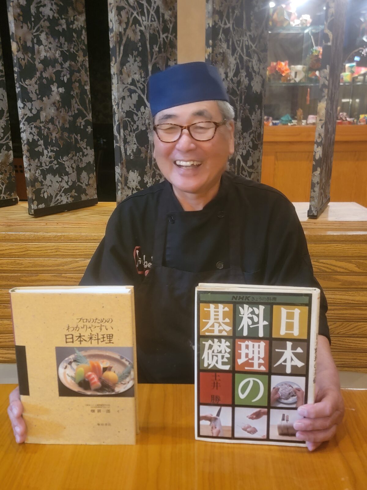 Fuji-san with the traditional Japanese culinary texts that shaped his training at Jinbeh