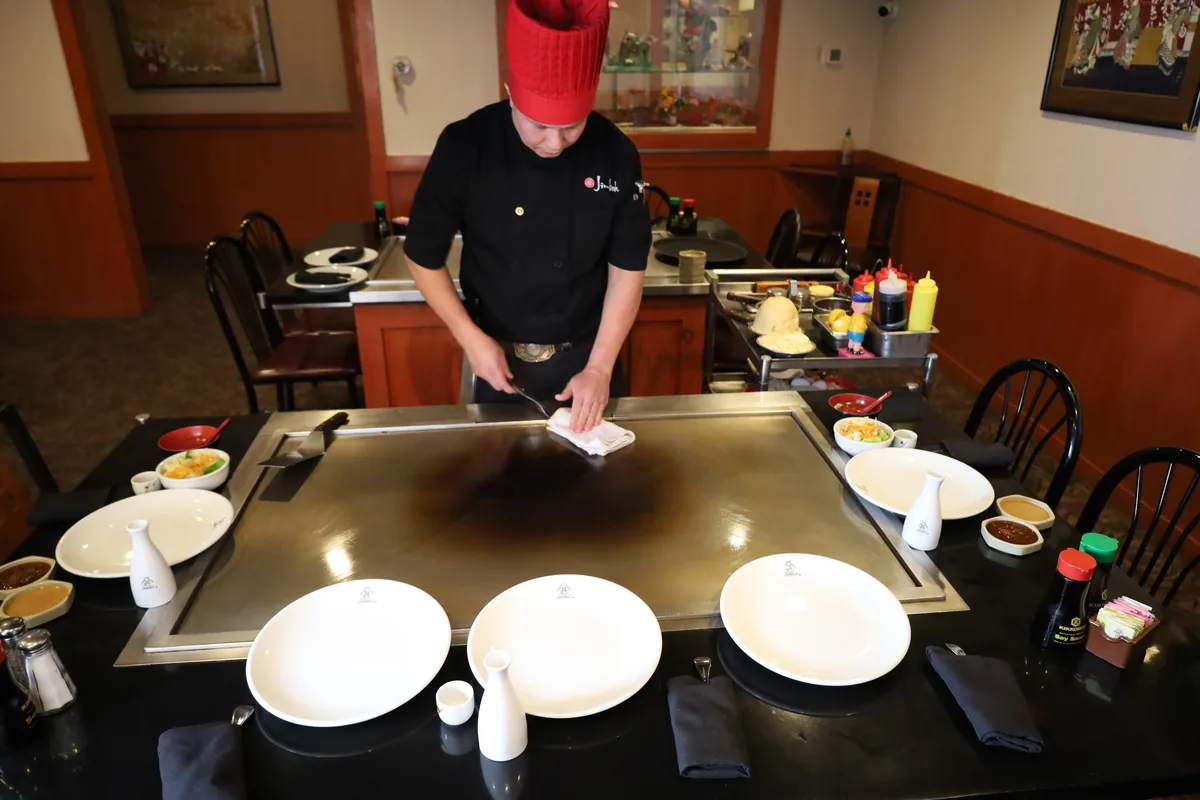 Jinbeh hibachi chef creating artistic heart-shaped fried rice at Lewisville TX location