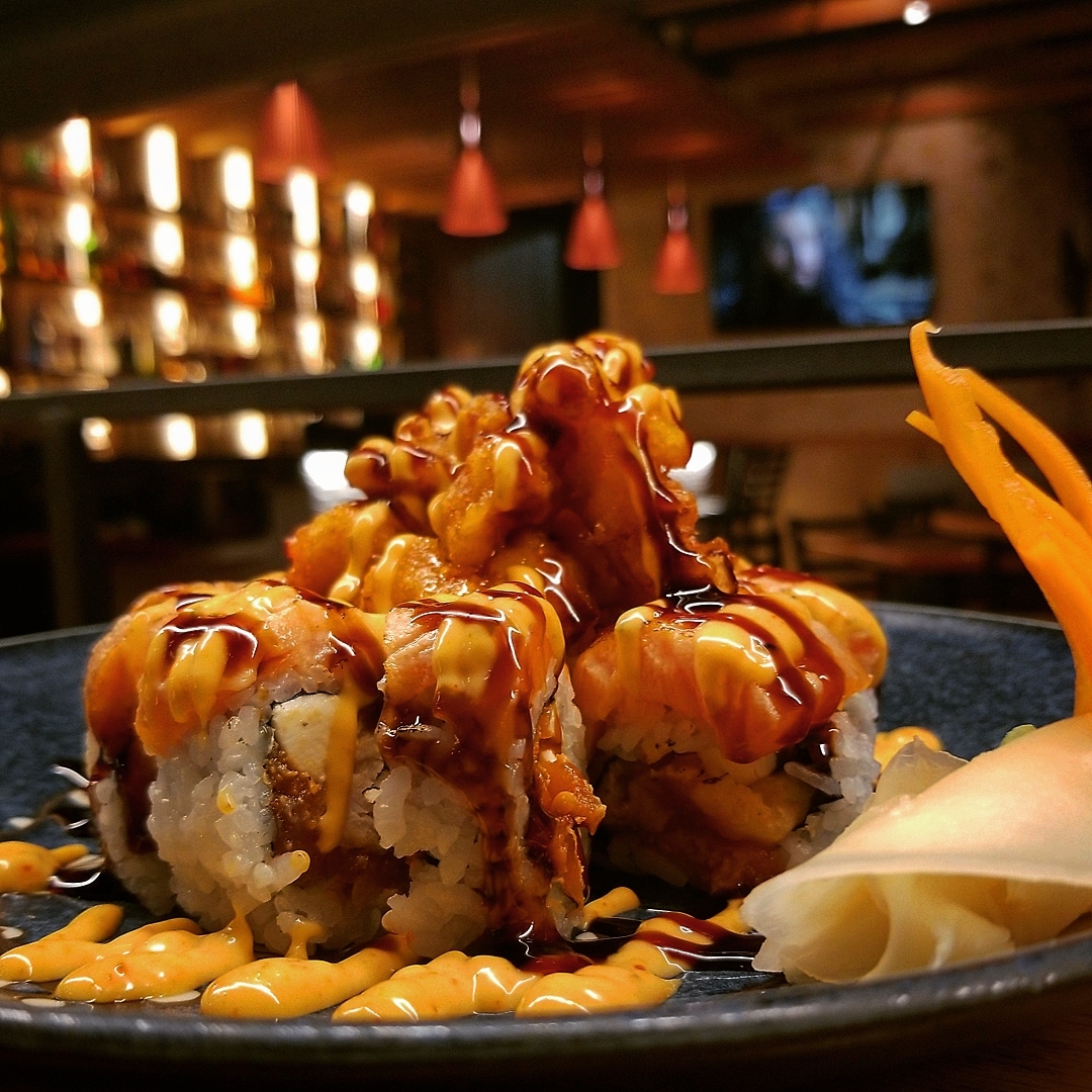 Deep-fried specialty roll with spicy mayo and eel sauce at Jinbeh sushi bar