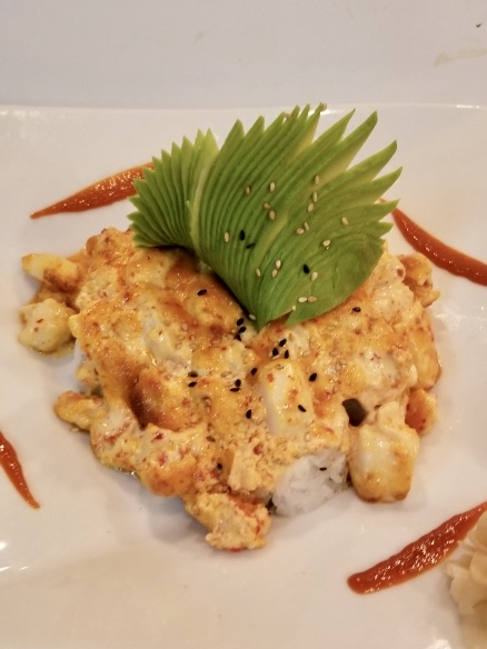 Volcano Roll, spicy crab and avocado with baked seafood topping
